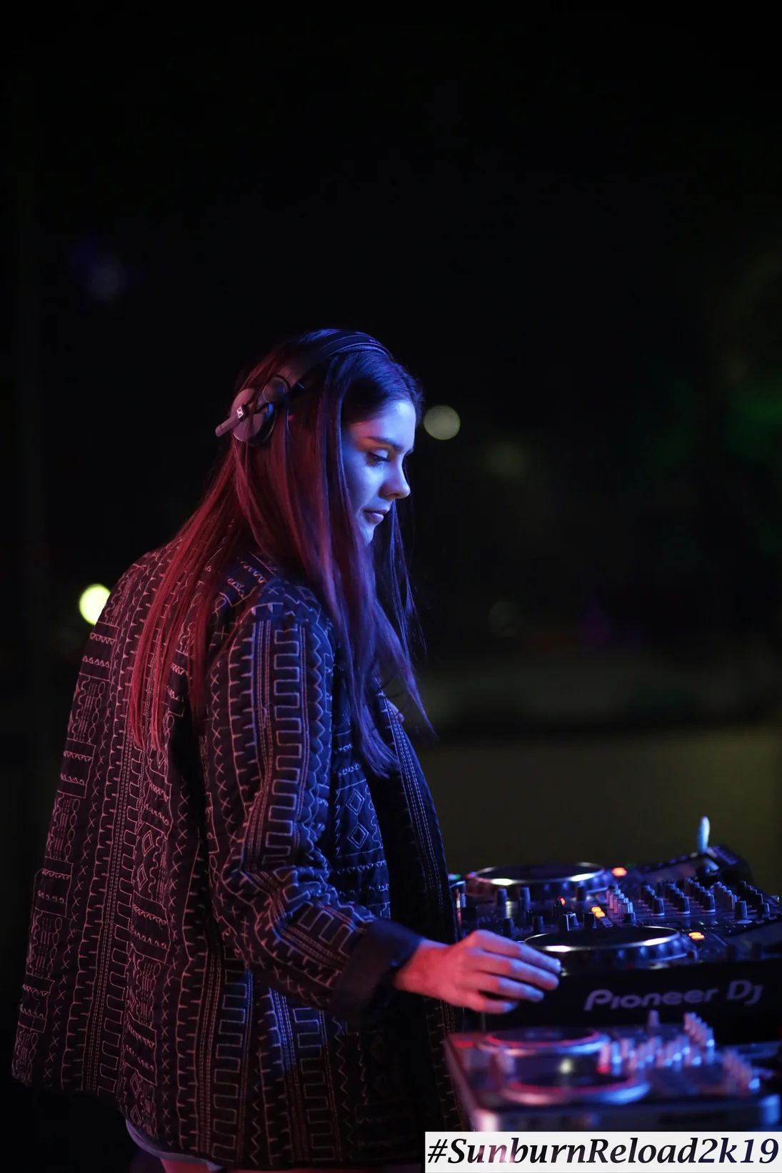 Mira Mira DJ performing at an outdoor event at night