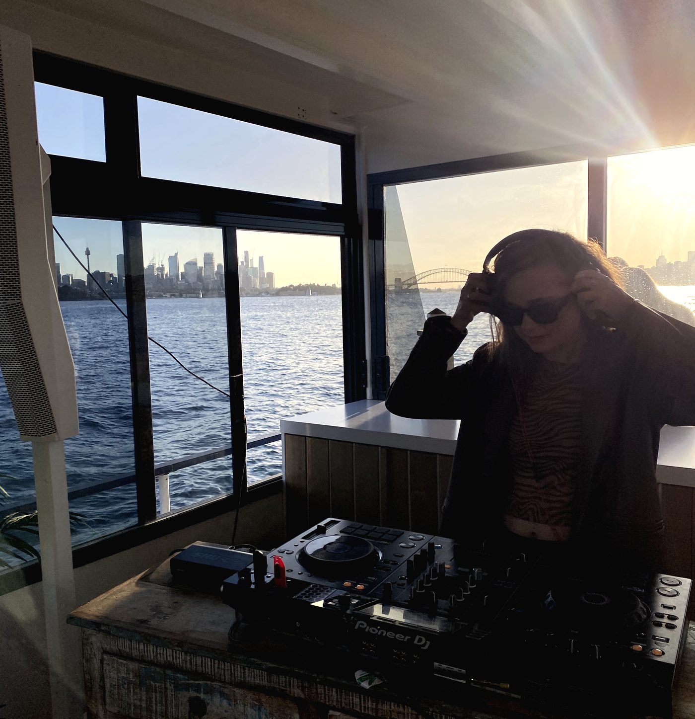Performing at a waterfront venue in golden light